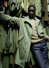 A.P.C. Journal - Man wearing green parka and blue jeans.