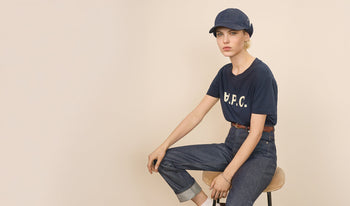 A.P.C. Women's Tops & T-shirts - Woman laying on bed wearing printed dress.