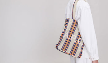 A.P.C. Men Sale Bags - Woman and man sitting together wearing coat and jeans.