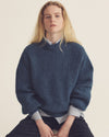 A.P.C. Sale - woman sitting in a sweater