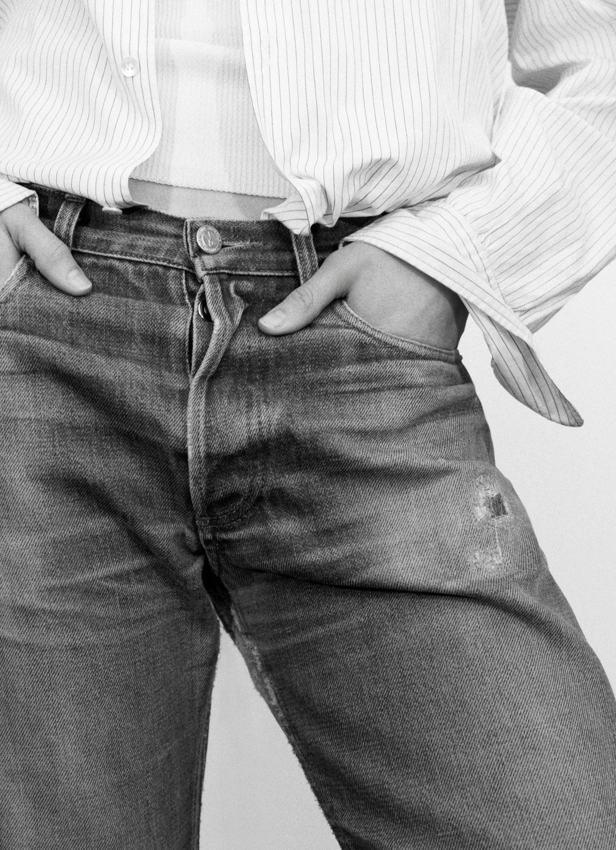 woman wearing striped shirt and faded blue jeans