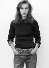 Woman wearing knit sweater and denim jeans
