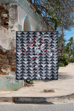 Quilt suspended above street corner