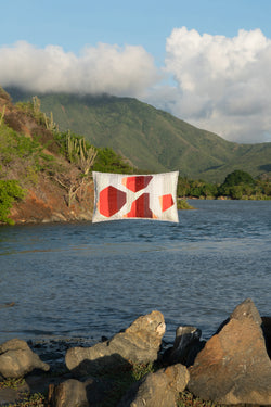 Pillow suspended above lake among mountains