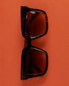 Sunglasses on orange background