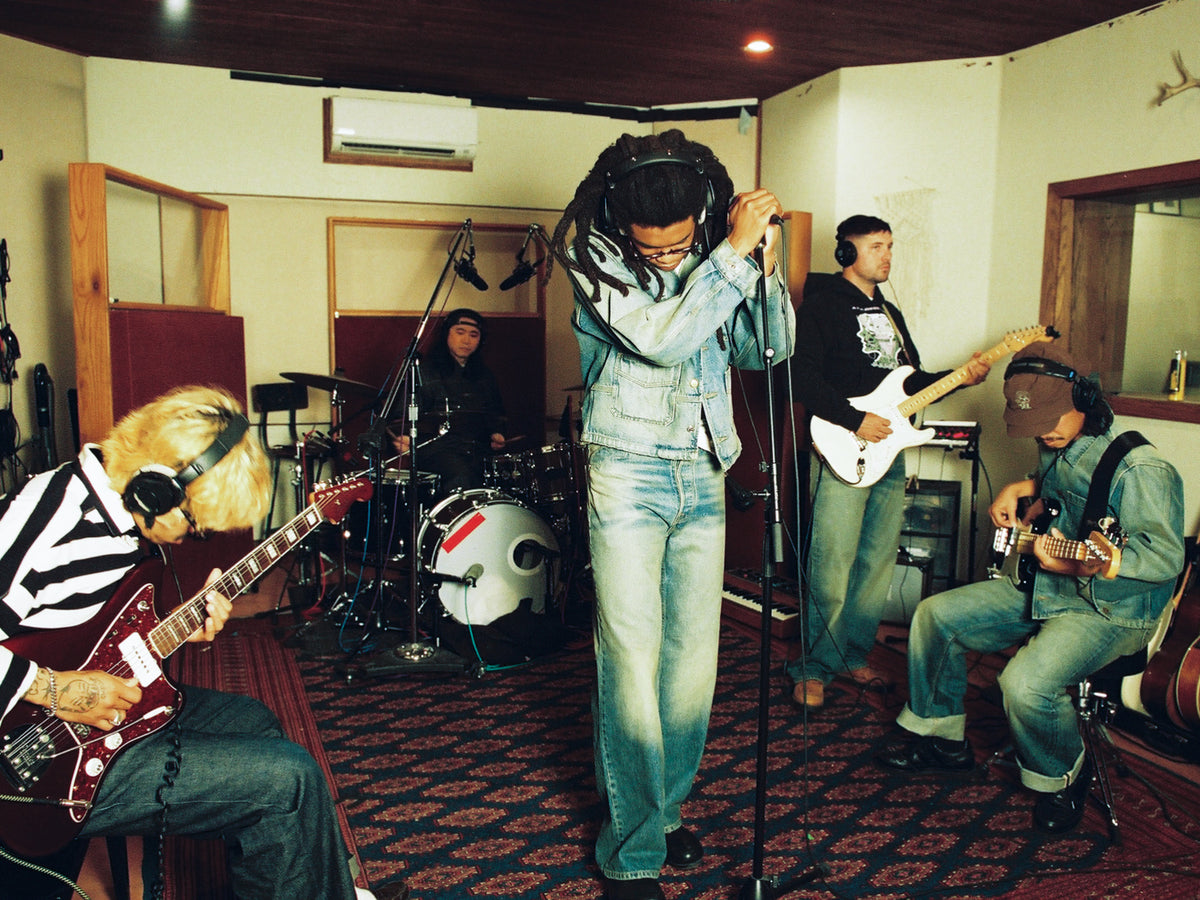 5 men in a recording studio playing various instruments
