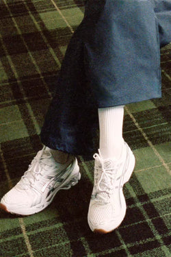 A.P.C. Asics - white sneakers against a green plaid carpet