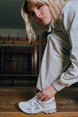 A.P.C. Asics - woman model tying shoelaces