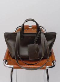 A.P.C. bag in a leather chair