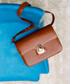 A.P.C. Box Leather - Brown Astra bag on chair.