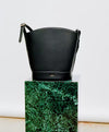 A.P.C. Grained Leather - Black Ana bag on stand.