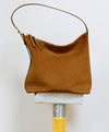 A.P.C. Suede - Brown Vera bag on stand.