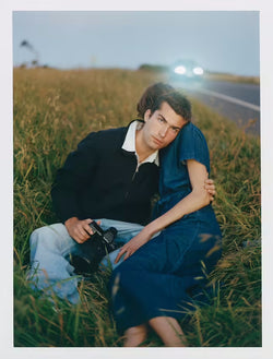 two models holding in a meadow