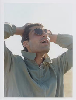 male model wearing glasses and looking to the sky