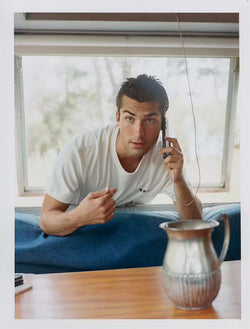 Male model pointing out to his own t-shirt